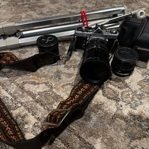 Vintage Olympus Silver and Black Camera with Lenses and Tripod